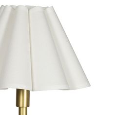 a white lamp with a gold base on a white background