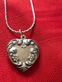 "Antique/Vintage Sterling Silver Heart Pendant with Chain Marked Holland 925 on the Heart and Sterling on the Chain. Signed 925 Sterling Silver Floral Heart Pendant. the beautiful flowered pendant measures 3/4\" wide x just over 3/4\" in length. The pendant is vintage/antique but the chain may be newer, marked STERLING on the clasp. The chain is a beautiful 24\" long with a wonderful link pattern. A very special necklace for a special person who appreciates vintage and antique silver. This was i Classic Heart-shaped Collectible Jewelry, Classic Heart Jewelry For Collectibles, Classic Heart Shaped Collectible Jewelry, Classic Heart-shaped Hallmarked Necklace, Vintage White Gold Jewelry With Heart Charm, Vintage Charm Jewelry For Valentine's Day Formal, Vintage Charm Jewelry For Valentine's Day Formal Occasion, Formal Vintage Charm Jewelry For Valentine's Day, Heirloom Hallmarked Necklace With Heart Pendant