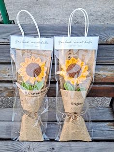 two bags with sunflowers are sitting on a bench