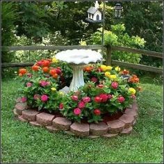 a garden with flowers and a birdhouse in the background that says, magic diy spring flower arrangements that give the garden a special charm