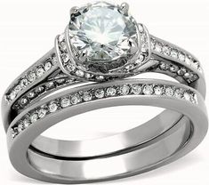 an engagement ring set with a white diamond in the center and two matching wedding bands