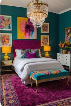 a bedroom with blue walls and purple carpeting, chandelier above the bed