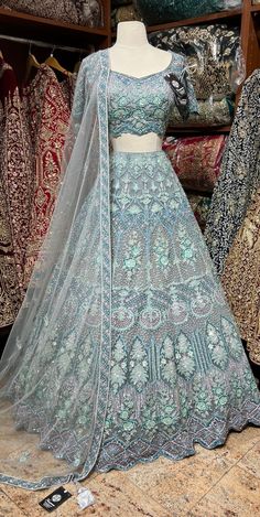 Powder blue craftsmanship with fine details of multicolor sequins, stone, pearl and cutdana nestled on sheer net fabric in floral embroidery bloom this lehenga. Includes a ready blouse paired with beautiful net dupatta. If you are planning to ace the grace of your D-day dress, then this Powder Blue is the best choice. Fabric: Net Size: 38/M Occasion: Wedding Ceremony or Reception WASH CARE INSTRUCTIONS - Please Dry clean only when it is applicable. Slight color variation is possible due to digit Pale Blue Lehenga, Bollywood Style Reception Lehenga With Intricate Design, Fusion Style Wedding Sharara With Dupatta, Festive Floor-length Lehenga With Intricate Design, Floor-length Lehenga With Intricate Design For Festive Occasions, Intricate Design Floor-length Lehenga For Festive Occasions, Bollywood Style Lehenga For Reception With Intricate Design, Festival Reception Lehenga With Intricate Design, Fusion Style Sharara For Wedding And Festivals