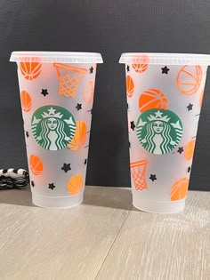 two starbucks cups with basketballs and stars on them