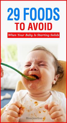 the cover of 29 foods to avoid when your baby is starting eating solids, with a photo of a baby holding a spoon in it's mouth