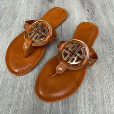 Tan Slip On Sandal With Gold Emblem Detail On Top Of Foot. Tts. Limit Style By Pierre Dumas Adjustable Tan Sandals For Vacation, Casual Tan Flat Flip Flops, Tan Round Toe Sandals For Beach, Comfortable Wedges Sandals, Boho Wedges, Comfortable Wedges, Tan Shoes, Tan Sandals, Walking Sandals