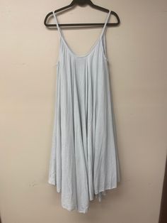 This Italian-made A-line dress is your perfect summer wardrobe piece! Light and airy in 100% cotton, it's comfy enough for a day of lounging with friends, but jazz it up with some accessories and you'll be ready for a night of fun. With a V-neck front and back, plus spaghetti straps, you'll look totally fab - no matter how you wear it! Casual Gray Summer Dress, White Cotton Lounge Dress, Gray Beach Dress For Spring, Relaxed Fit Cotton Dress For Lounging, Relaxed Cotton Lounge Dress, Relaxed Fit Cotton Lounging Dress, Flowy A-line Cotton Sundress, Spring Cotton Dresses For Lounging, Cotton Lounge Dress For Spring