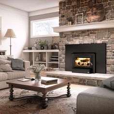 a living room filled with furniture and a fire place next to a stone wall fireplace