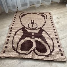 a crocheted rug with a teddy bear on it