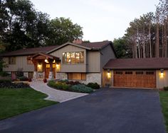 a large house in the evening with lights on