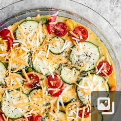 a pizza topped with cucumbers, tomatoes, cheese and parmesan bread