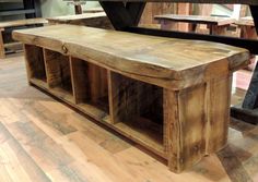 a wooden bench sitting on top of a hard wood floor