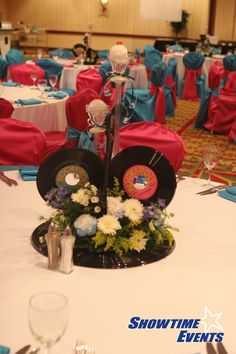 the table is set up for an event with blue and red linens on it