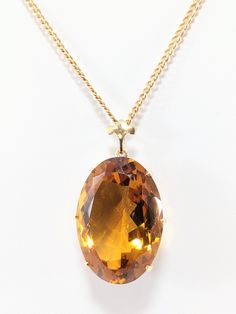 14 KT Gold Oval Citrine Pendant  Cuban Chain - 21.75" x 2mm  Fleur De Lis Bail Pendant - 19mm by 28mm Hallmark "14K " on Chain Total Weight: 11.4 DWT/ 17.7 Grams Please see our photos. Our shipping includes USPS First Class Mail with Insurance and Delivery Confirmation. All offers will be reviewed Monday through Friday from 9 AM-5 PM Gold Jewelry With Large Oval Cabochon Stone, Formal Oval Amber Necklace, Classic Oval Jewelry With Large Pendant, Formal Oval Necklace With Large Stone, Classic Oval Large Pendant Jewelry, Luxury Amber Oval Necklace, Oval Large Stone Vintage Necklace, Vintage Oval Necklace With Large Stone, Vintage Oval Large Stone Necklaces