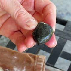 a person holding a rock in their hand