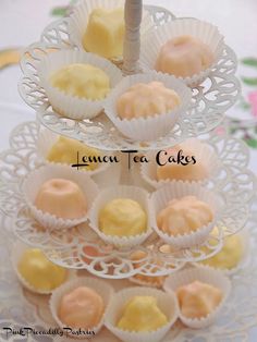 there is a cake stand that has several small cakes on it and the words lemon tea cakes above them