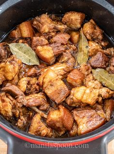 chicken and pork adobo in a pot with the title above it reads, chicken and pork adobo