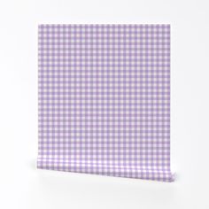 a purple and white checkered cloth on a white surface