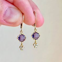 Amethyst Earrings, February Birthstone, Tiny Purple Diamond Shape Earrings, Lavender Dangle Drops Gold or Silver, Minimalist Gift for her These darling small earrings feature faceted tiny diamond shape Amethyst stones prong set in gold filled or sterling silver. Suspended from the dark purple gemstones are delicate dangle elements with 3 white topaz stones that add great sparkle but hardly any length. These earrings are minimal, understated and timeless, also very feminine and delicate Perfect g Purple Dainty Earrings With Ear Wire, Dainty Purple Earrings With Ear Wire, Dainty Nickel-free Purple Earrings, Dainty Purple Nickel-free Earrings, Dainty Purple Jewelry With Matching Earrings, Dainty Purple Round Earrings, Dainty Gemstone Dangle Earrings, Dainty Purple Gemstone Earrings, Purple Drop Crystal Earrings As Gift