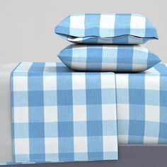 blue and white checkered bedding with matching pillow cases on top of each other