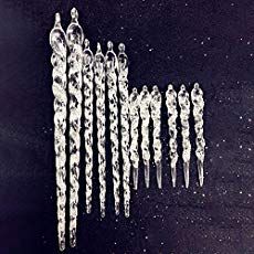 an image of ice crystals hanging from strings in the air on a black surface with white dots