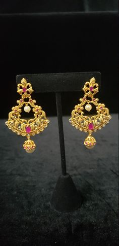 "This Earrings set has an excellent finish and gives out an exquisite sense of style. If you are looking for an amazing Fashion Jewelry set for special occasions such as Anniversary, Engagement, Party, Wedding, or for gifting, then your search ends here. Handmade Indian Temple Jewelry, best to wear it for traditional ceremonies or Indian wedding. This bridal jewelry has an ethnic finish. It has Cubic Zircon stones with semi-precious ruby and emeralds. It is a Bollywood style one gram jewelry. Th Chandbali Temple Jewelry Earrings With Elegant Design, Elegant Chandbali Temple Jewelry Earrings, Elegant Earrings For Diwali Celebration, Formal Jeweled Earrings For Festivals, Bollywood Style Celebration Earrings, Bollywood Style Elegant Earrings For Celebration, Elegant Dangle Earrings For Festive Occasions, Ornate Jeweled Earrings For Festive Occasions, Festive Dangle Earrings With Elegant Design