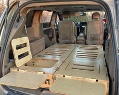 the back end of a van with its doors open and cargo trays in place