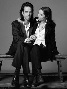 black and white photograph of two people sitting on a bench