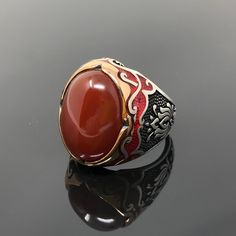 -Stone Type: Natural Red Agate (aka Aqeeq) -Stone Dimensions: 2.1 cm x 1.5 cm -Metal Type: Sterling Silver(925k) & Bronze Details (Yellow Part) -Weight of the Item: 17gr (Approx.) All items comes in a special gift box. If you don't see your size, please ask, we may produce your size. You are looking at the high quality handcrafted silver ring. All of our items have been designed and produced by ourselves ,so all our items comes with 1 year warranty as well. International shipping(customers f Red Oval Engraved Signet Ring, Red Polished Finish Signet Ring As Gift, Red Carnelian Signet Ring For Anniversary, Red Oval Enamel Ring For Gift, Oval Agate Signet Ring For Gift, Oval Red Enamel Ring For Gift, Red Oval Signet Ring Collectible, Gift Agate Signet Ring With Polished Finish, Oval Red Signet Ring Collectible