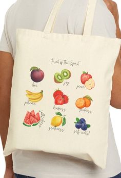 Fruit of the Spirit Canvas Tote Bag This 100% cotton bag comes in one size - 15" x 16"- perfect for everyday wear. The bag features 20" handles (made from the same canvas), making it easy to carry even with a week's worth of shopping. .: 100% cotton canvas .: Heavy fabric (12 oz/yd² (406.9 g/m .: Sewn-in label Fruit Tote Bag Painting, Fruit Tote Bag, Christian Tote Bags Paint, Christian Tote Bag Design, Jesus Tote Bag, Bible Tote Bag, Spirit Bags, Christian Tote Bags, Christian Crafts