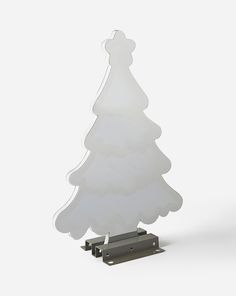 a plastic christmas tree on a metal stand