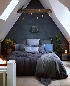 an attic bedroom with a large bed and two candles