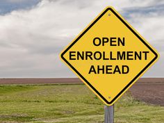 a yellow sign that says health insurance changes ahead in front of an open field and sky