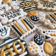 decorated cookies are displayed on a table for 60th birthdays and other celebration items to be eaten