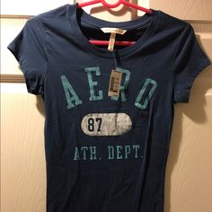 Navy Blue Aeropostale T-Shirt, New With Tags. Fitted, Runs Small. Fitted Blue T-shirt With Text Print, Fitted Pre-shrunk Blue T-shirt, Casual Stretch Pre-shrunk T-shirt, Aeropostale Shirts, Aeropostale, Colorful Shirts, Color Blue, Navy Blue, Womens Tops