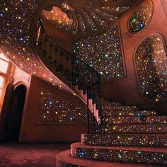 a spiral staircase with lots of stars on the ceiling