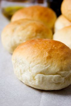 several rolls sitting on top of a piece of wax paper next to each other,