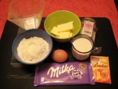 ingredients to make pumpkin muffins laid out on a black tray with red tablecloth