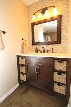 a bathroom vanity with two baskets under the sink