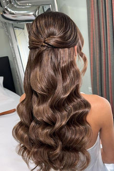 Chic and sophisticated half-updo featuring voluminous curls in luxurious chocolate brown tones, exuding elegance and charm for any special event. // Photo Credit: Instagram @kxhairdesign Half Up Half Down Wedding Hair Elegant, Long Curled Hair Half Up Half Down, Wavy Short Hair Wedding, Brown Wedding Hair Updo, Half Updo Wedding Hairstyles, Wavy Half Updo Hairstyles, Hairstyle Half Updo, Hairstyles Prom Half Up, Wavy Curled Hairstyles