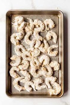 doughnuts on a baking sheet with powdered sugar in the middle, ready to be baked