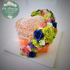 the cake is decorated with flowers and icing