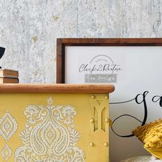 a yellow trunk sitting on top of a table next to a sign and some books