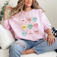 Thank you for checking out my Ew Valentine's Day sweatshirt with candy hearts. These shirts are so soft and comfy. Choose between pink, sport grey, sand, or white. These are unisex fit, so double check the size guide before ordering. This sarcastic Valentine's shirt is perfect for anti Valentine's people or anyone that is so over Valentine's Day. If you like this listing, please visit my shop. I'm a full time band teacher that sells laser items, apparel, ornaments, and unique gifts. teamfreitas.etsy.com/shop Ew Valentine Sweatshirt Women Anti Valentine Shirt Candy Hearts Sweatshirt Single Valentine Shirt Sarcastic Valentine Funny Valentine Shirt Pink Long Sleeve T-shirt With Heart Graphic, Cute Long Sleeve T-shirt With Heart Print, Sweet Long Sleeve Tops With Graphic Print, Sweet Long Sleeve Graphic Print Top, Pink Long Sleeve Top With Heart Graphic, Cute Crew Neck Top With Heart Patch, Cute Long Sleeve Tops With Heart Graphic, Cute Long Sleeve Top With Heart Graphic, Cute Valentine's Day Graphic Print Sweatshirt