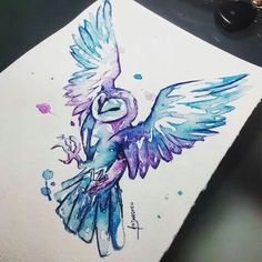 a drawing of a bird with blue and purple colors on it's wings, sitting on top of a piece of paper