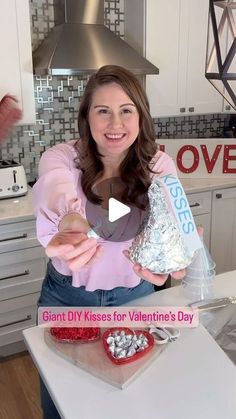 a woman holding two bags of valentine's day treats