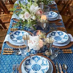 a table set with blue and white plates