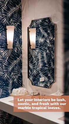 a bathroom with palm leaves on the wall and two mirrors above it that say, let your interiors be lush, exotic, and fresh with our marble tropical leaves