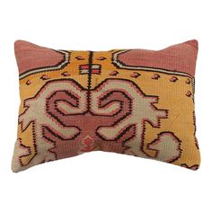 an orange and pink decorative pillow on a white background