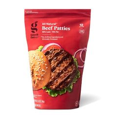 a bag of beef patties with onion and lettuce on it, sitting next to a hamburger